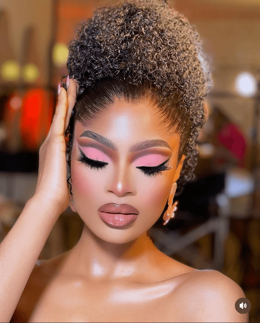 Pink-toned eyeshadow glam with sharp winged liner