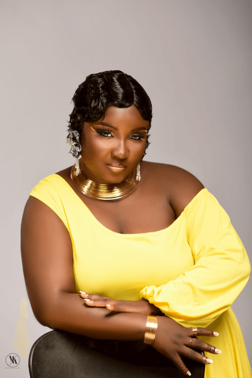 Bold gold cut-crease glam with yellow off-shoulder gown